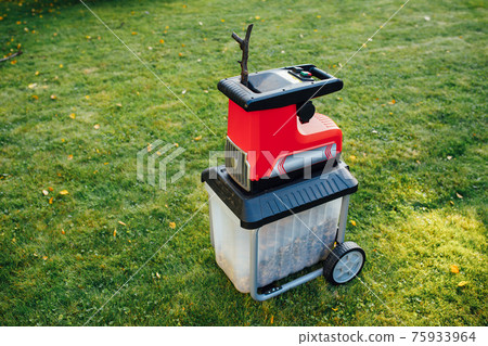 garden chipper, electric shredder (mulcher), green grass background 75933964