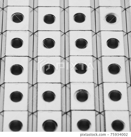 slide screw nuts in a row, abstract industrial background slide screw nuts in a row, abstract industrial background 75934002