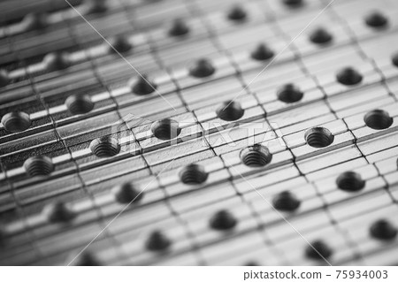 slide screw nuts in a row, abstract industrial background slide screw nuts in a row, abstract industrial background 75934003