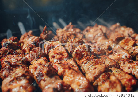 grilled barbecue meat on skewers with smoke grilled barbecue meat on skewers with smoke 75934012