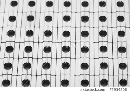 slide screw nuts in a row, abstract industrial background slide screw nuts in a row, abstract industrial background 75934208