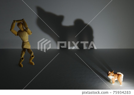 A drawing doll scared by the shadow of a giant beast projected by a puppy 75934283