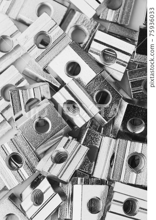 slide screw nuts heap, closeup view slide screw nuts heap, closeup view 75936033