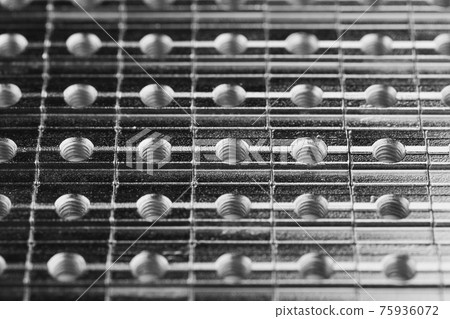 slide screw nuts in a row, abstract industrial background slide screw nuts in a row, abstract industrial background 75936072
