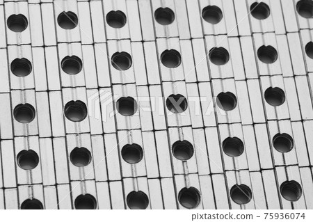 slide screw nuts in a row, abstract industrial background slide screw nuts in a row, abstract industrial background 75936074