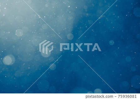 blue light background with snowflakes particles 75936081
