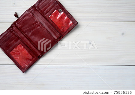 Leather purse on a white wooden background 75936156