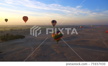 Aerial motion video riding hot air balloon over Luxor Egypt valley of the king Unesco heritage site sunrise Aerial motion video riding hot air balloon over Luxor Egypt valley of the king Unesco heritage site sunrise 75937430