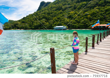 Kids on tropical beach. Child on resort jetty. Kids on tropical beach. Child on resort jetty. 75937718