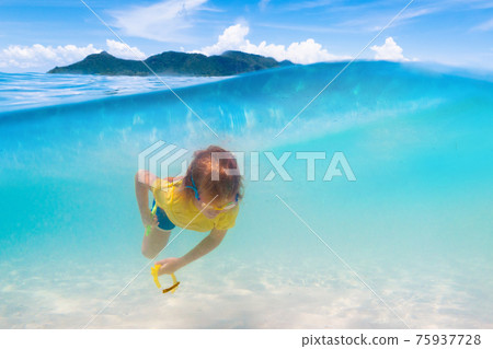 Kids playing on beach. Children play at sea. Kids playing on beach. Children play at sea. 75937728