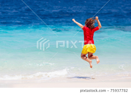 Kids playing on beach. Children play at sea. 75937782