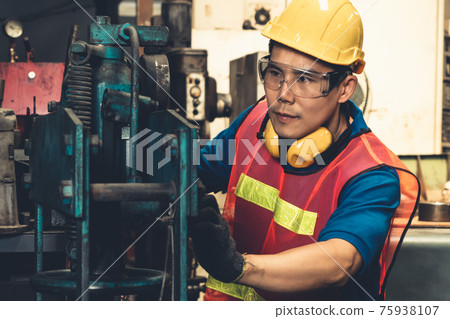 Skillful factory worker or engineer do machine job in manufacturing workshop 75938107