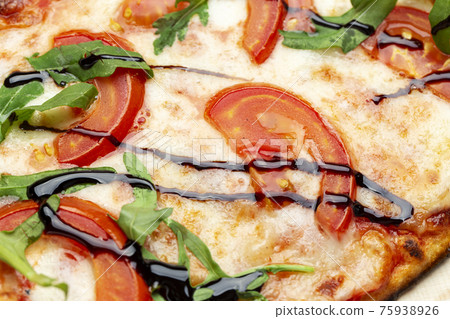 Delicious pizza, which includes tomatoes, cheese, arugula, peppers. Delicious pizza, which includes tomatoes, cheese, arugula, peppers. 75938926