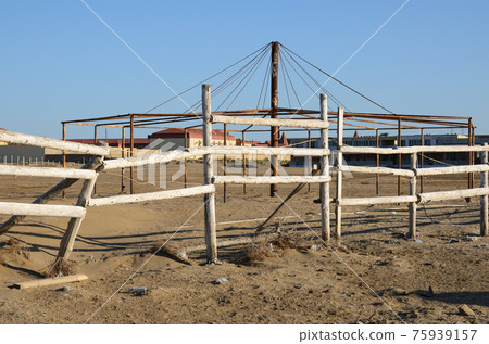 Wooden fence on an abandoned summer beach 75939157