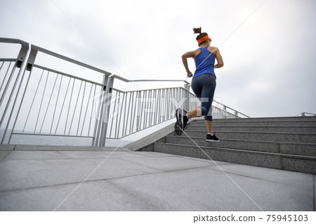 Healthy lifestyle fitness sports woman runner running on seaside trail 75945103