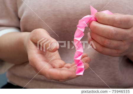 How to make silk ribbon rose flower. Step 7. Step by step photo instruction. Woman hands making decorative flower How to make silk ribbon rose flower. Step 7. Step by step photo instruction. Woman hands making decorative flower 75946535