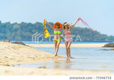 Portrait of woman posing outdoors at the sea beach Portrait of woman posing outdoors at the sea beach 75946758
