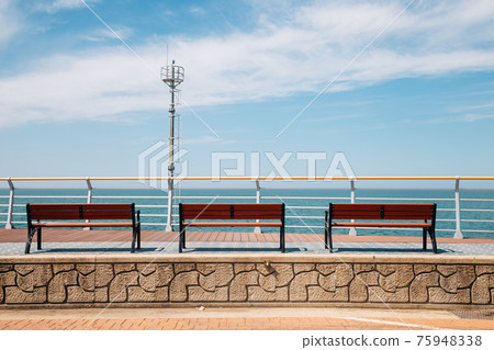 Empty bench and sea at Saemangeum Seawall in Gunsan, Korea Empty bench and sea at Saemangeum Seawall in Gunsan, Korea 75948338