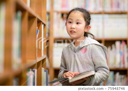 在圖書館選擇一本書的女孩 75948746