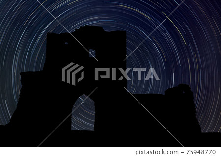 Castle at night with startrail in the background 75948770