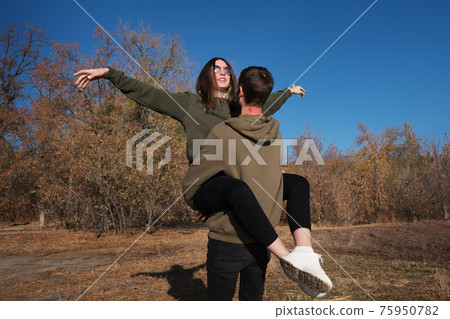 Happy Young Couple Walk In Autumn Park 75950782