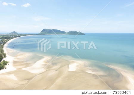 Sea and beach with blue sky background on a calm day. Sea and beach with blue sky background on a calm day. 75953464