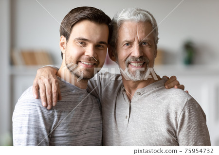 Portrait of happy old father and adult son hugging Portrait of happy old father and adult son hugging 75954732