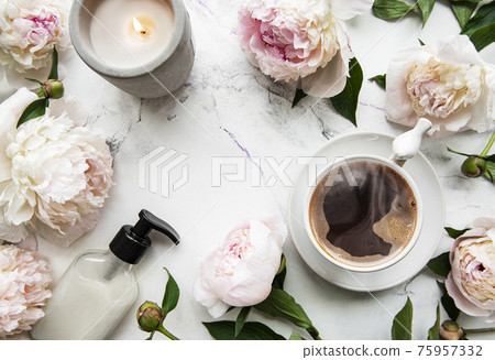 Pink peony flowers and cup of coffee Pink peony flowers and cup of coffee 75957332