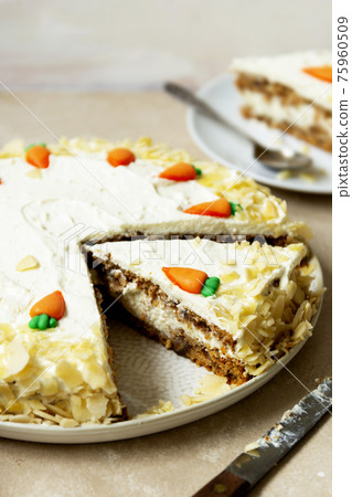 Carrot cake with walnuts an whipped cream, homemade easter cake baking, top view. Whole round cake. 75960509