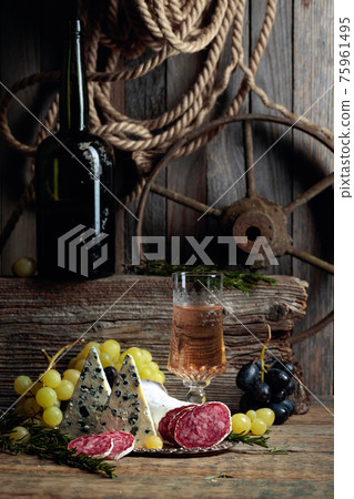 Rustic still life with white wine and snacks. 75961495