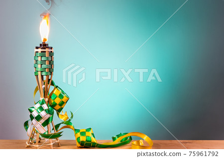Traditional Malay torch and decorative ketupat lit up during Hari Raya Aidilfitri celebration Traditional Malay torch and decorative ketupat lit up during Hari Raya Aidilfitri celebration 75961792