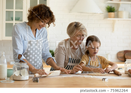 Happy three generations of women baking together 75962264