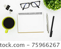 White office desk table with blank notebook page and supplies. Top view, flat lay. 75966267