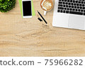 Wood office desk table with laptop computer, latte coffee, smartphone and supplies. Top view with copy space, flat lay. 75966282