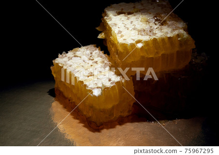 honeycomb covered with wax on dark background honeycomb covered with wax on dark background 75967295