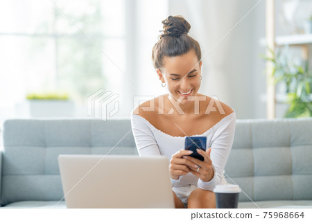 woman working on laptop at home. 75968664