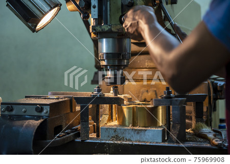 The operation of NC milling machine by technician operator. The shop floor operation by NC milling machine. The operation of NC milling machine by technician operator. The shop floor operation by NC milling machine. 75969908