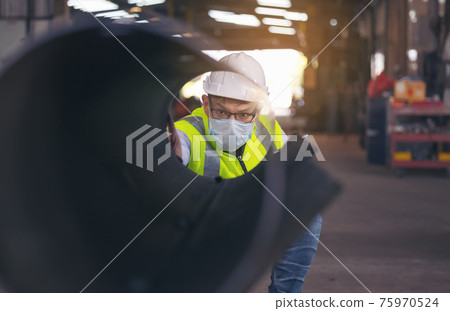 Engineers examine new coated pipe in factory, Ventory Check Engineers examine new coated pipe in factory, Ventory Check 75970524