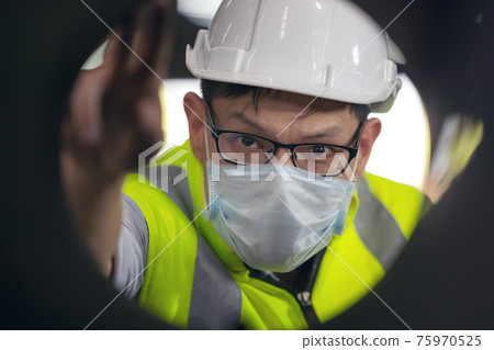 Engineers examine new coated pipe in factory, Ventory Check Engineers examine new coated pipe in factory, Ventory Check 75970525