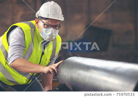 Engineers examine new coated pipe in factory, Ventory Check 75970533