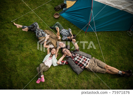 Cheerful family realxing on a camp Cheerful family realxing on a camp 75971876