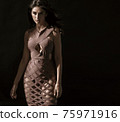 Portrait of a young, brunette, classy woman posing in shade 75971916