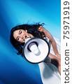 Elegant woman yelling with a bullhorn - communication concept 75971919