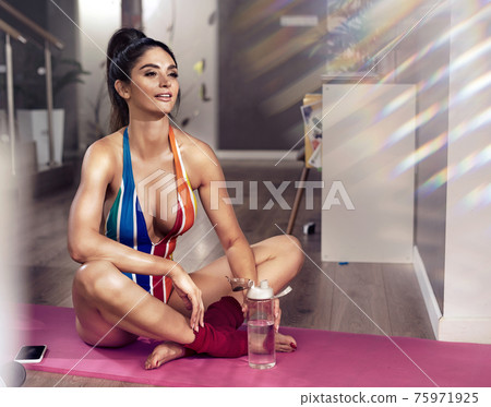 Portrait of a fit lady having a training break Portrait of a fit lady having a training break 75971925