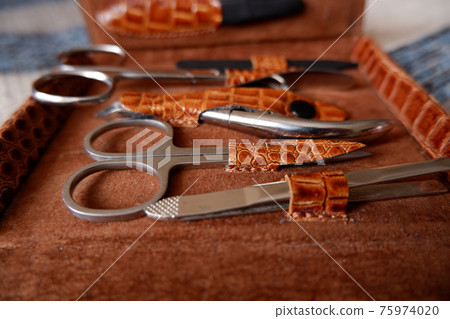 a set of manicure accessories in a brown case-bag. selective focus a set of manicure accessories in a brown case-bag. selective focus 75974020