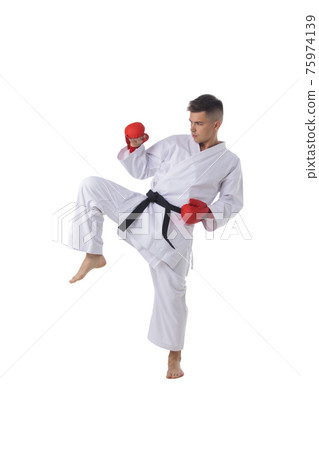 Man training taekwondo on white 75974139
