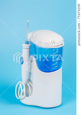 Electronic Tooth Irrigator for personal home usage on blue background. 75974200