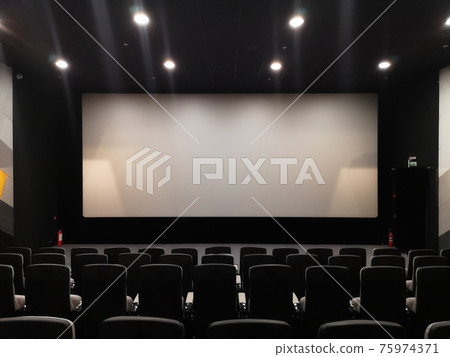 Cinema screen and empty chairs. Absence of visitors during coronavirus pandemic Cinema screen and empty chairs. Absence of visitors during coronavirus pandemic 75974371