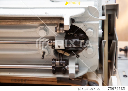 Parts and components of sewing machine tilted to one side during repair Parts and components of sewing machine tilted to one side during repair 75974385