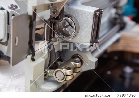 Parts and components of sewing machine tilted to one side during repair Parts and components of sewing machine tilted to one side during repair 75974386